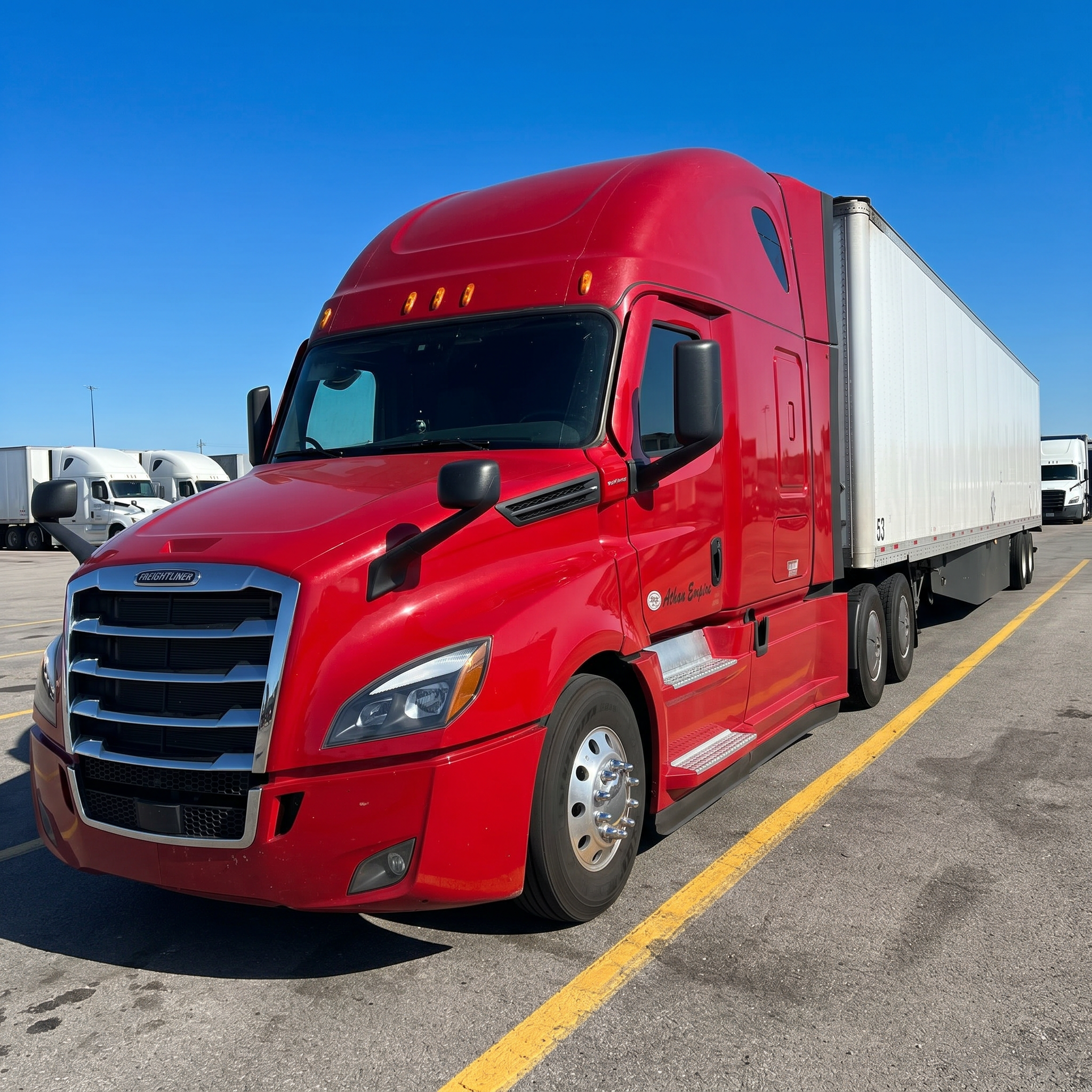Red Freightliner Cascadia hauling a 53' dry van trailer