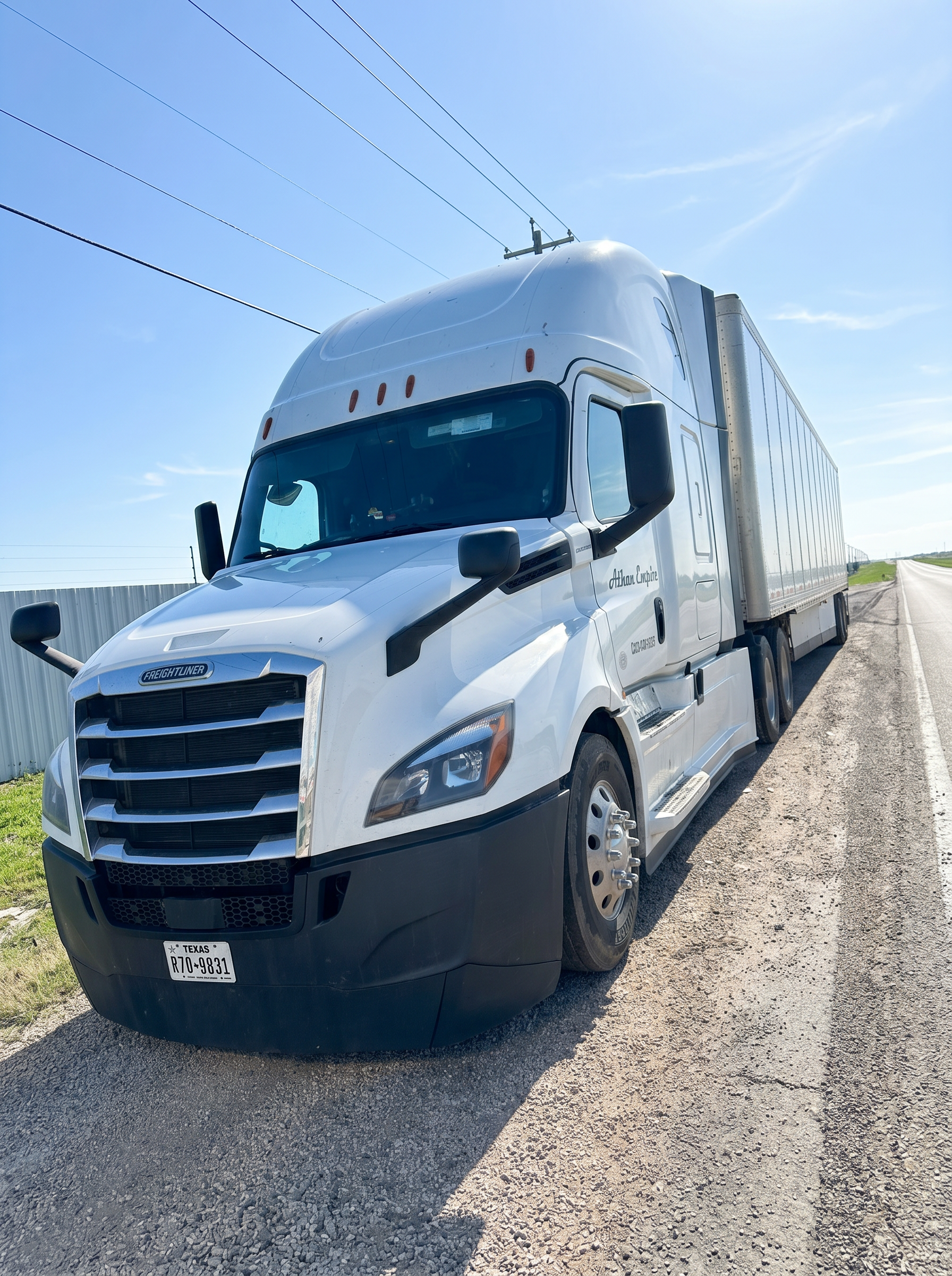 White Freightliner Cascadia with 53' dry van trailer
